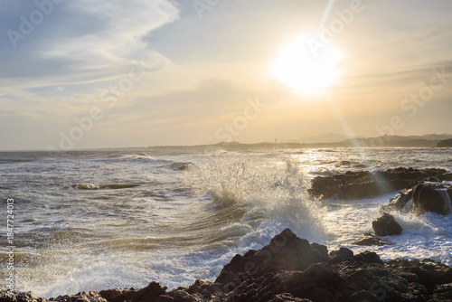 The waves and black rocks under the setting sun stirred up lang'hua