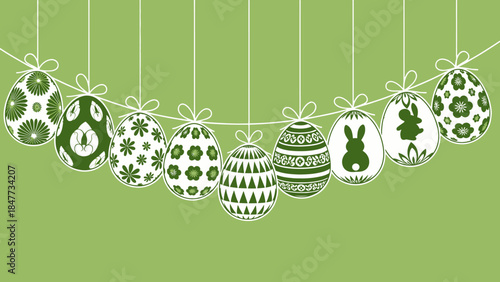 A string of nine white Easter eggs with various green patterns and bunny silhouettes hanging against a light green background.