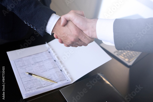 Business handshake with contract