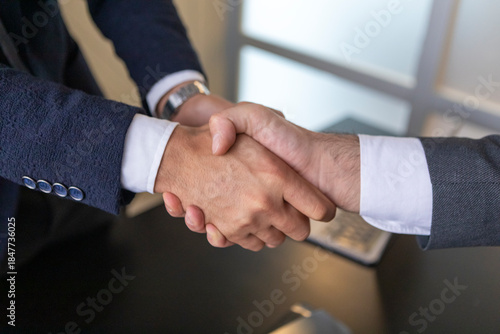 Business handshake with contract