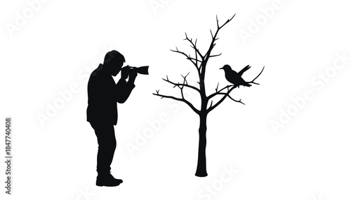A photographer silhouetted against a white background taking a picture of a bird on a tree.