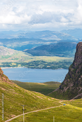 Bealach na Bà; Applecross - Breathtaking mountain lake valley scene with winding road through green hills and cliffs