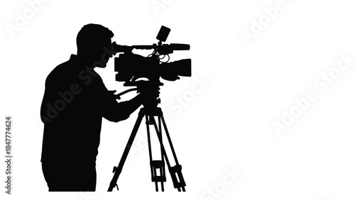 Silhouette of a man operating a video camera on a tripod isolated on white background