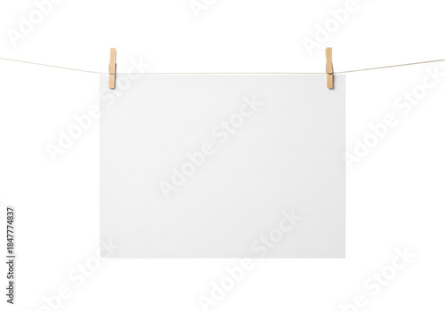 blank paper hanging on clothesline isolated on white