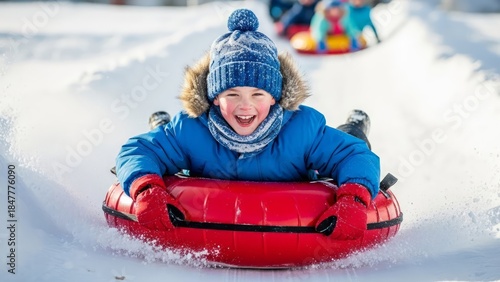 A happy child slides down the slope in a red snow tube, dressed in bright winter clothes. AI generated.