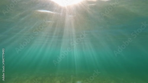 Underwater View of Sun Rays Shining Through Clear Water
