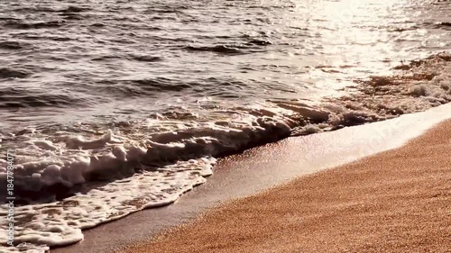 Serene Ocean Waves Washing onto Beach Shore at Sunset