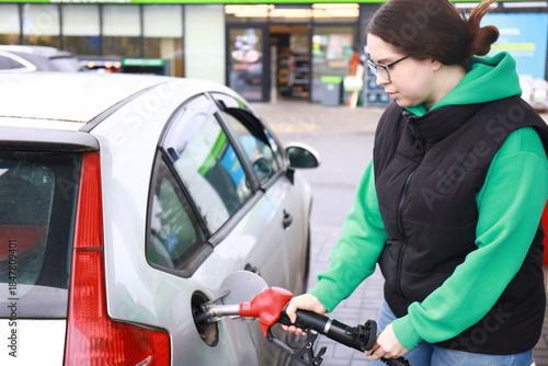 the girl at the gas station refuels the car
