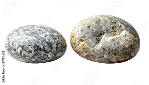 Two oval, rounded stones sit against a stark black background, showcasing intricate textures. Their surface reflects various colors, details revealed