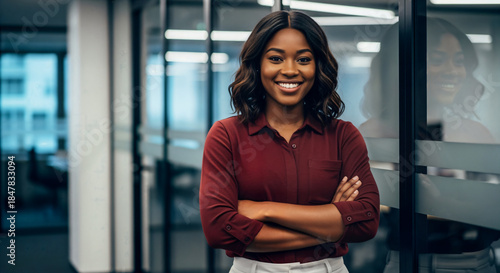 Confident young businesswoman standing with arms crossed in a modern corporate office Free Download Confident young businesswoman standing with arms crossed in a modern corporate office - GFXLoad