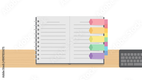 organized open planner with colorful sticky tabs and a computer keyboard on a wooden desk surface