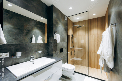 Fotografie Sophisticated restroom featuring premium fixtures and plush robes