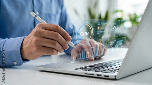 Professional pointing a stylus at a laptop screen, holographic 