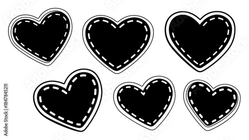 Playful collection of six black fabric hearts featuring white dashed stitching patterns perfect