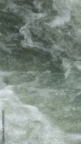 Vertical close up of a fast flowing river. A clear mountain river. Ecological and environmental concept. Realtime footage, 4K