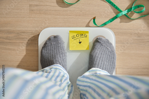фотографія Person standing on a weighing scale aiming for weight loss in 2026