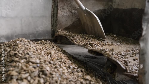 Industrial equipment sorting raw materials. A vibrating screen separator machine sorting crushed stone for processing in a quarry or factory