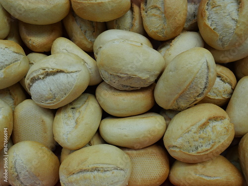 Fresh bread rolls, ready to be topped with sausage and cheese for a buffet.