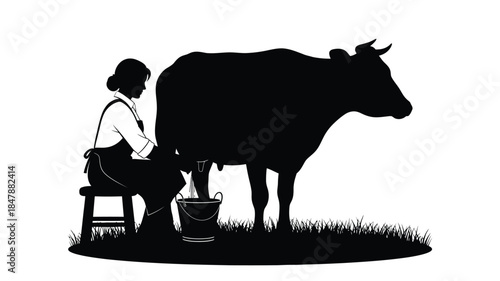 A silhouette of a woman milking a cow in a rural setting