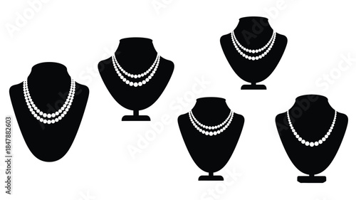 Black silhouettes of jewelry display busts showcasing various pearl necklaces