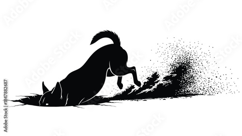 Silhouette of a dog digging in the dirt creating a splash of dust