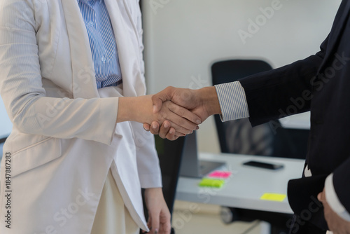 Wallpaper Mural Young business leaders shake hands in the office after a successful merger and acquisition meeting; a fruitful negotiation. Torontodigital.ca