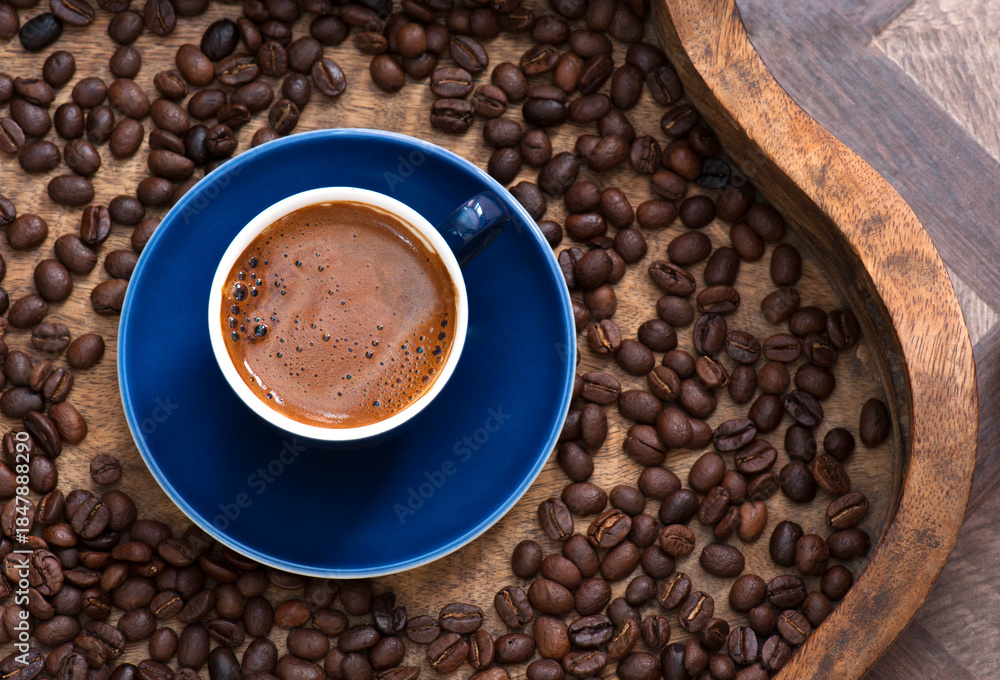Fototapeta premium Blue Cup of Turkish Coffee on Tray filled with beans