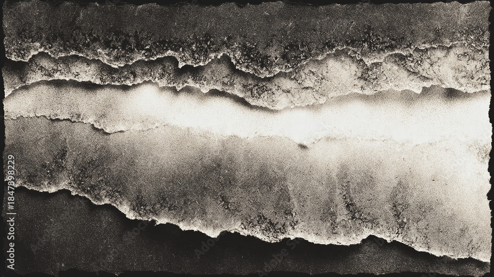 Naklejka premium Abstract black and white torn paper strips arranged in layers, creating an artistic effect with unique textures.