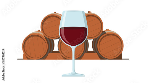 A glass of red wine is presented in front of several wooden barrels, suggesting a winery or cellar setting.