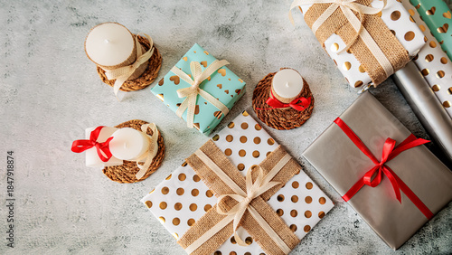 Wallpaper Mural Wrapped presents and natural candles arranged for a warm holiday atmosphere. Minimalist and elegant gift-giving flat lay Torontodigital.ca