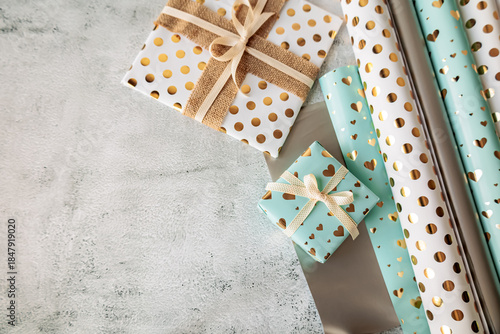 Wallpaper Mural Flat lay with gift boxes and wrapping paper rolls on textured background. Cozy festive atmosphere with space for text on the left Torontodigital.ca