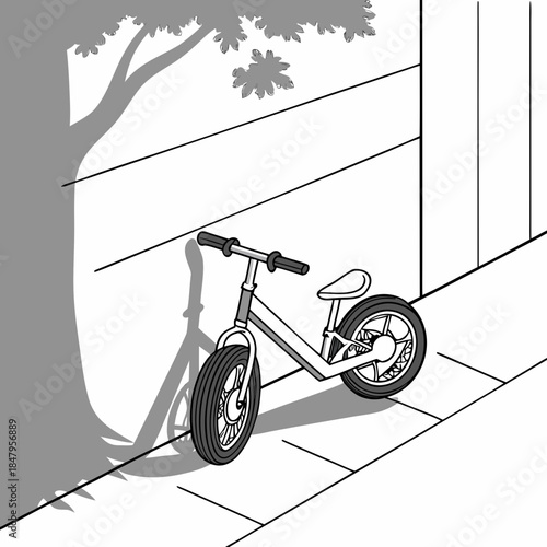 Balance bike without pedals leaning against wall training bike