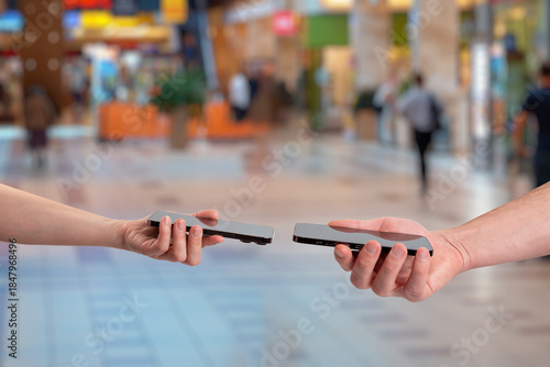 Wireless data exchange between two smartphones using close range communication, representing contact sharing, phone number transfer, digital identity, and modern peer to peer connectivity