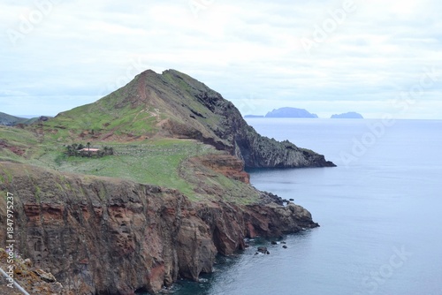 Green rocky peninsula surrounded by the Atlantic Ocean in Madeira