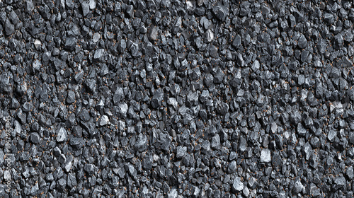Detailed texture of dark asphalt or tarmac, featuring small stones