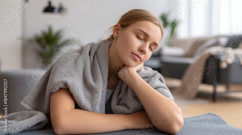 Free Download Young woman resting on yoga mat at home after workout. Towel over shoulders, eyes closed, calm expression. Wellness, recovery, mindfulness, healthy lifestyle concept - GFXLoad