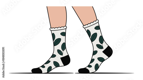 Pair of feet wearing white socks with green leaf pattern and black toes and heels Keywords: socks, feet, legs, walking, standing, fashion, clothing, apparel, accessory, footwear, white, green