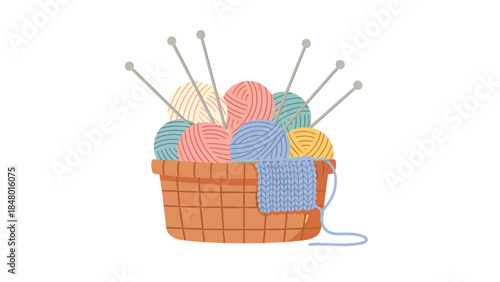 Colorful balls of yarn and knitting needles are nestled inside a woven basket with a partially knitted blue fabric project.