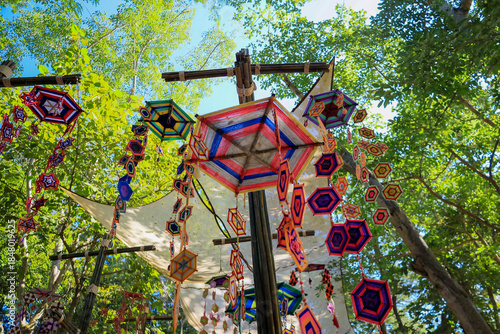 ิThis is a Spider Web Tung, a traditional Lanna flag made of threads, used for religious ceremonies.