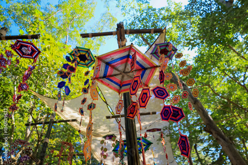 ิThis is a Spider Web Tung, a traditional Lanna flag made of threads, used for religious ceremonies.