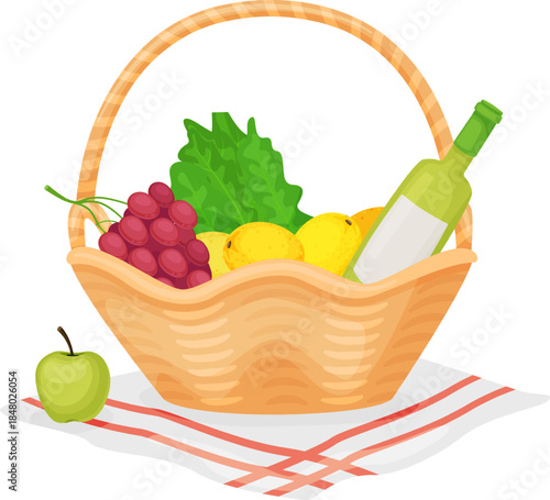 Picnic basket filled with fresh fruit, greens and wine