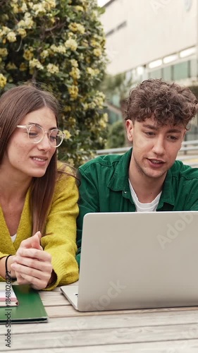 Two students working and learning together using laptop to study for university exams
