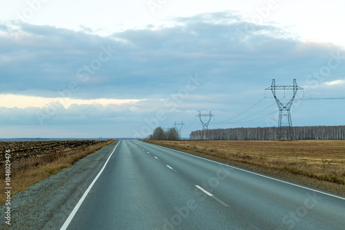 A road with a power line pole on the side