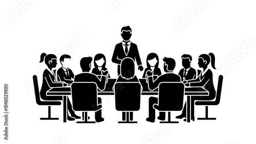 Business meeting with team around a table and leader standing