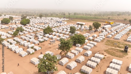 Aerial view of rows of white tents create a stark contrast against the dusty earth, a temporary refuge under a hazy sky, Gbanjiba Guma Local Government, Makurdi, Benue, Nigeria.