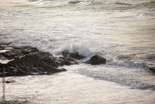 Waves crashing on the rocks at Godrevy Beach in Cornwall UK.