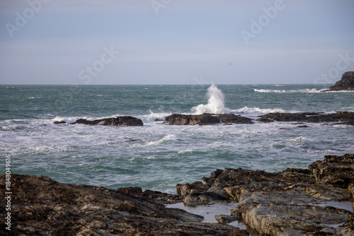 Waves crashing on the rocks at Godrevy Beach in Cornwall UK.