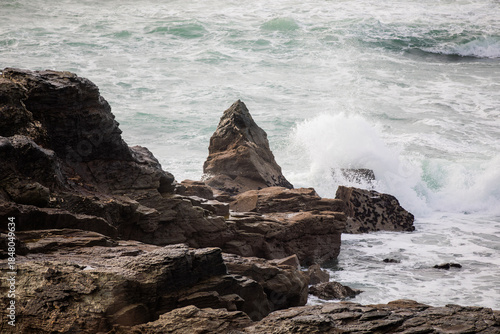 Waves crashing on the rocks at Godrevy Beach in Cornwall UK.