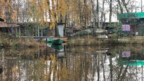 boat dock in autumn, boats on the shore and on the water, landscape
