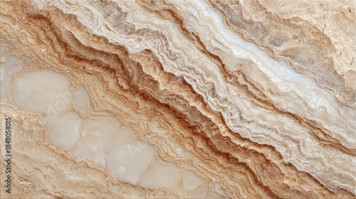 Close-up of striated stone surface, exhibiting swirling layers of tan, brown, and white hues. The natural patterns showcase a flowing, organic aesthetic